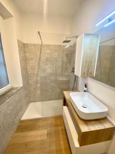 a bathroom with a white sink and a shower at CASA NOVA Luxury Apartment Suite Fichi d'India in Nova Milanese
