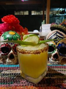 a drink with a lime on a table with skulls at La Casona Eco-Lodge Tortuguero in Tortuguero