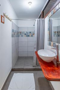 a bathroom with a sink and a shower at La Casona Eco-Lodge Tortuguero in Tortuguero