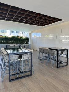 a group of tables and chairs in a building at K Avenue Seaview Nearby Kota Kinabalu Airport Free Car Park & Water Filter in Kota Kinabalu
