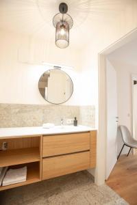 a bathroom with a sink and a mirror at Refugium Bad Ischl in Bad Ischl