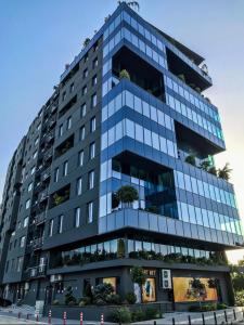 a tall building with a lot of windows at Sunlight Luxe Apartment in Skopje