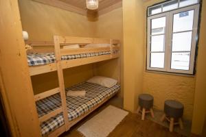 two bunk beds in a room with a window at Casa do Outeiro in Meda