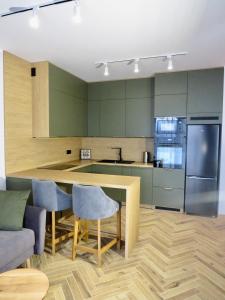 a kitchen with green cabinets and a table and chairs at Marco Polo in Jaworze