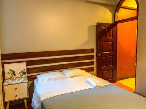 a bedroom with two beds and an open door at CASITA CHANCHAMAYO in La Merced