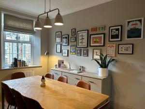 a dining room with a table and some pictures on the wall at Coral Cottage Amble in Amble