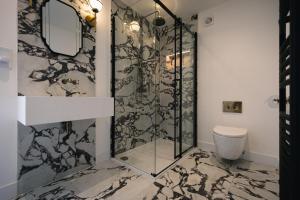 a bathroom with a shower and a toilet at KOKO Cabins in Copthorne