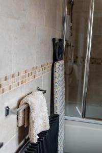 a towel rack in a bathroom with a shower at Malvern - Beautiful 2 bed upper flat Ideal for Contractors Free Parking in South Shields