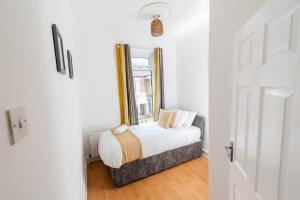 um quarto com uma cama e uma janela em Malvern - Beautiful 2 bed upper flat Ideal for Contractors Free Parking em South Shields