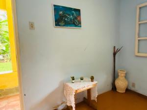 a table in a room with a motorcycle on the wall at Sítio arco íris in Mauá