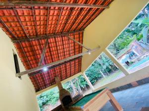 a room with a large window with a roof at Sítio arco íris in Mauá