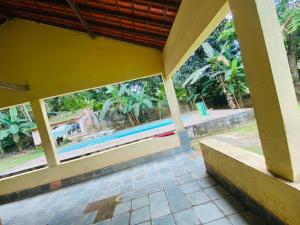 a view of a pool from the porch of a house at Sítio arco íris in Mauá