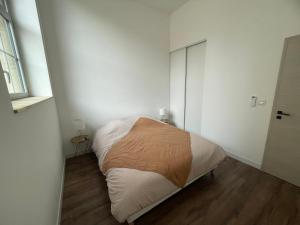 a small bedroom with a bed and a window at Appartement avec terrasse in Dole