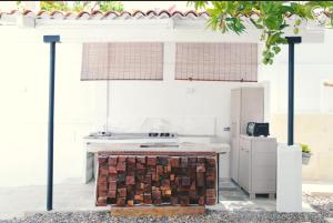 a white kitchen with a stove and a counter top at Blue Sand House B&B in Cartagena de Indias