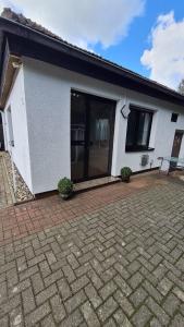 a white house with a brick patio in front of it at Ferienwohnung W.Esel in Wesel