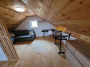 a living room with a couch and a table at Domek na Szczycie u Basi in Udryń