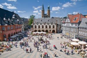 a group of people walking around a city square at FeWo Goslar Harz in Goslar