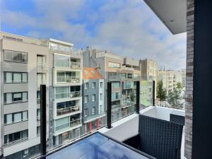an apartment balcony with a view of buildings at Residence Central Park in Ostend +3 photos
