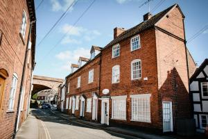 an old brick building on a city street at Whispering Place in the heart of Bewdley in Bewdley