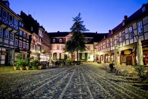 a cobblestone street in an old town at night at FeWo Goslar Harz in Goslar