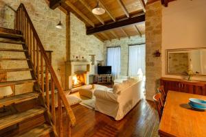 a living room with a staircase and a fireplace at Beyazhan Hotel in Alaçatı