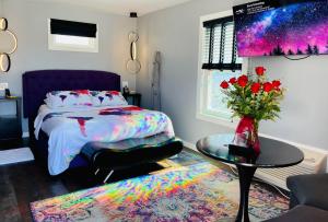a bedroom with a bed and a table with a vase of flowers at EO Bungalows, Black Hills in Custer