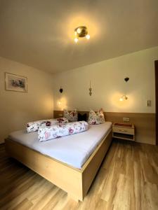 a bedroom with a large bed with white sheets at Haus Reiterer in Neustift im Stubaital