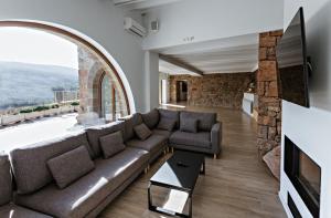 a living room with a couch and a tv at Masoveria la Boba in Vilanova de la Aguda