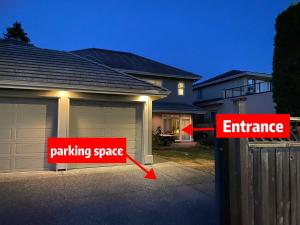 a house with a garage with an entrance and a parking space at Lucky suite, two-bedroom suite in Richmond close to YVR in Richmond