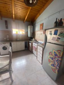 a kitchen with a refrigerator and a stove at Departamento Trelew in Trelew