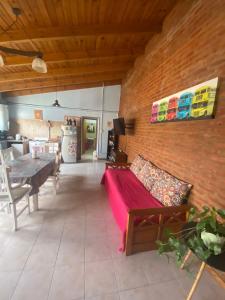 a living room with a couch and a brick wall at Departamento Trelew in Trelew
