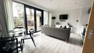 a living room with a couch and a table at The Stables, Chester - Luxury Apartments by PolkaStays in Chester