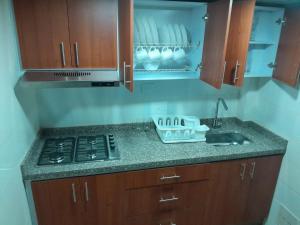 a kitchen with a stove and a counter top at Casa Hotel Palermo 49 in Bogotá