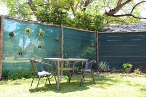 a table and chairs in a yard with a fence at Sunny Stay in Groblersdal