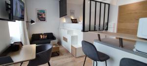 een woonkamer met stoelen en een tafel en een bank bij Studio cosy rénové-2 pers-Quartier Halles-Bureau in Pau