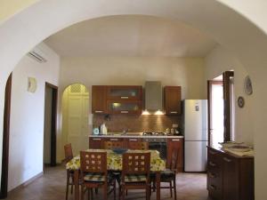 a kitchen with a table and chairs and a refrigerator at Hiera in Acquacalda