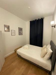 a small bedroom with a bed and a window at Appartement cosy 10 min stade de France in Saint-Denis