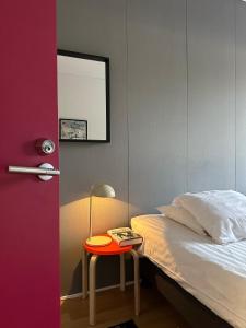 a bedroom with a bed and a table with a lamp at The Rooms Airport - 20Rooms in Vantaa