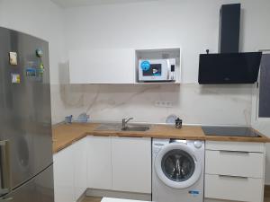 a kitchen with a sink and a washing machine at Casita isabelita in Valle de Santa Inés