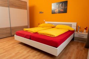 una camera con letto con lenzuola gialle e rosse di Art City Studio Kassel 10 a Niestetal
