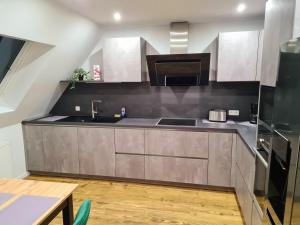 a kitchen with a sink and a stove at Moderne Ferienwohnung mit Aussicht in Bad Oeynhausen +11 photos