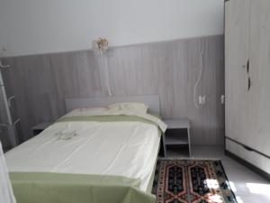 a small bedroom with a bed and a rug at Casa Mari in Sibiu