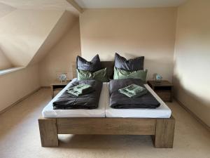 ein Bett mit zwei Kissen auf einem Zimmer in der Unterkunft 205 qm "Traumtor" mit Sauna, Whirlpool, Kamin und 3 Terrassen mit Blick in die Böhmisch Sächsische Schweiz in Dresden