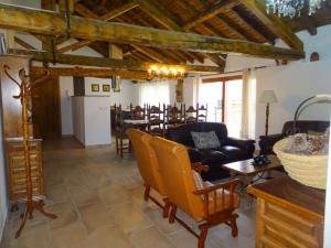 a living room with yellow chairs and a table at Damajuana in Villoslada