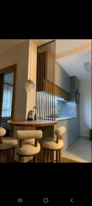 a kitchen with a table and stools in a room at Apartman Bagic in Zlatibor