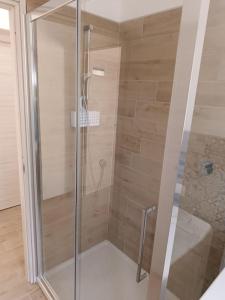 a shower with a glass door in a bathroom at suite4relax - near poetto beach in Quartu SantʼElena
