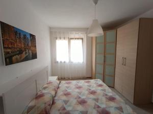 a bedroom with a large bed and a window at suite4relax - near poetto beach in Quartu SantʼElena