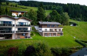 an aerial view of a large house on a green field at Chalet Bergmueller in Schladming