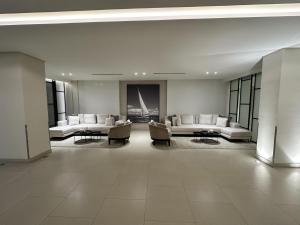 a large room with couches and chairs in a building at Marassi Beach Residence in Rayyā