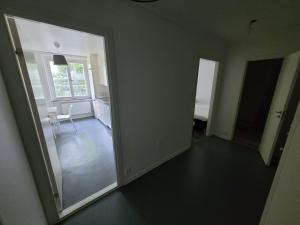 an empty room with a door open to a kitchen at Home Inn KG49 in Stockholm